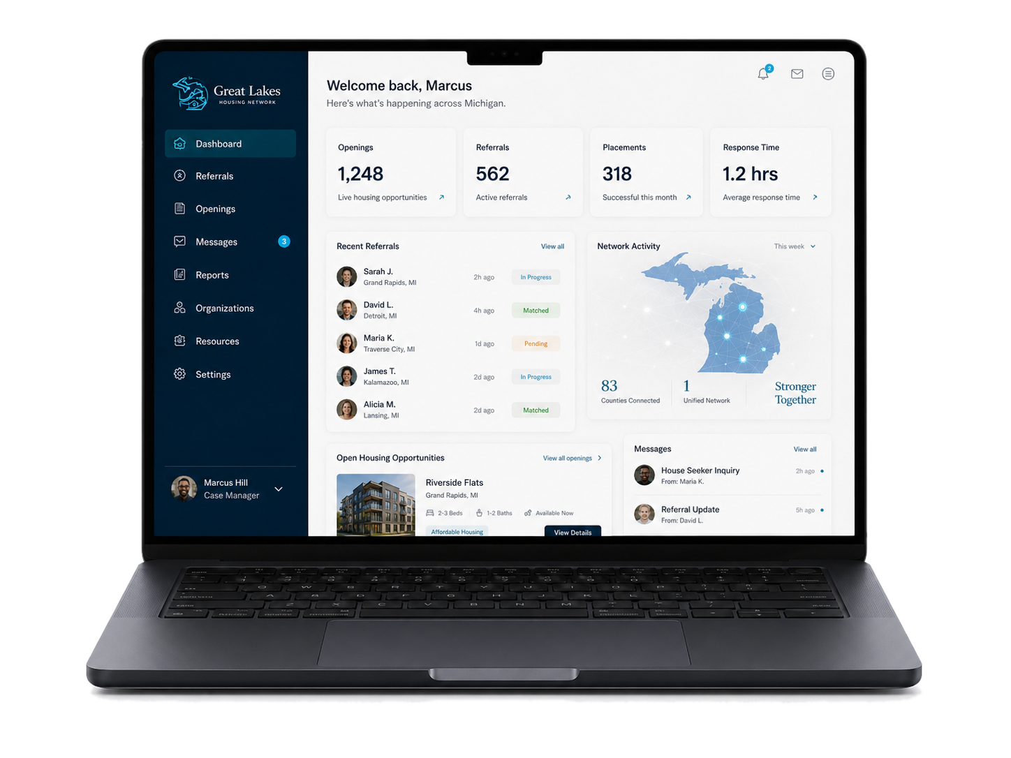Laptop showing the Great Lakes Housing Network case-manager dashboard with live openings, referrals, and network activity